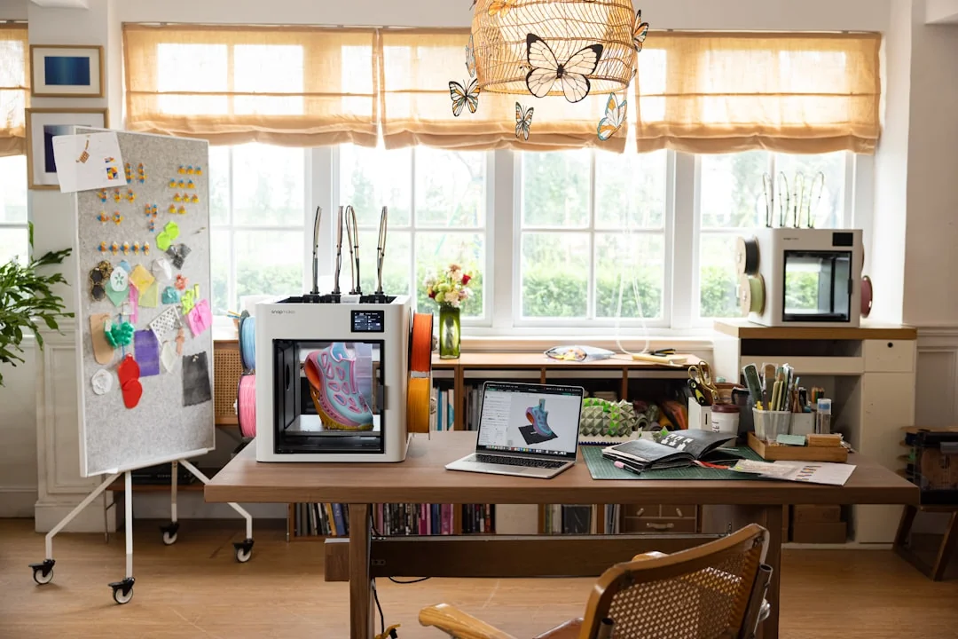 A laptop resting on a bed with web design software open, setting up a cozy workspace.